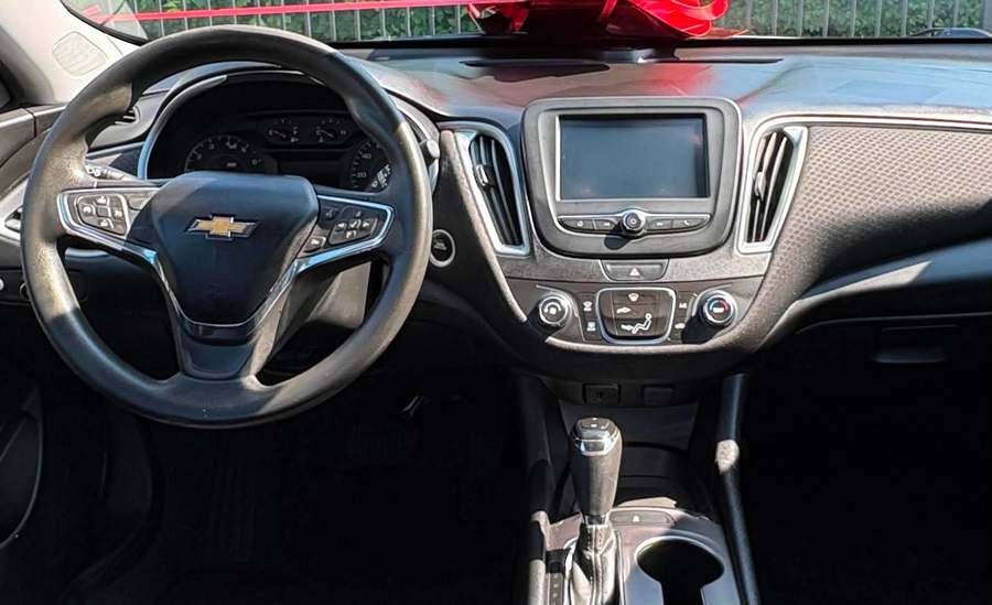 The same Malibu dashboard cleaned and dressed after the interior detail